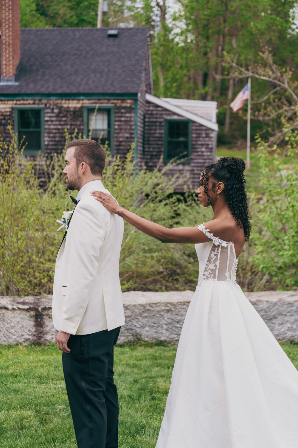 Interracial couple sharing a first look moment outdoors at their spring wedding.