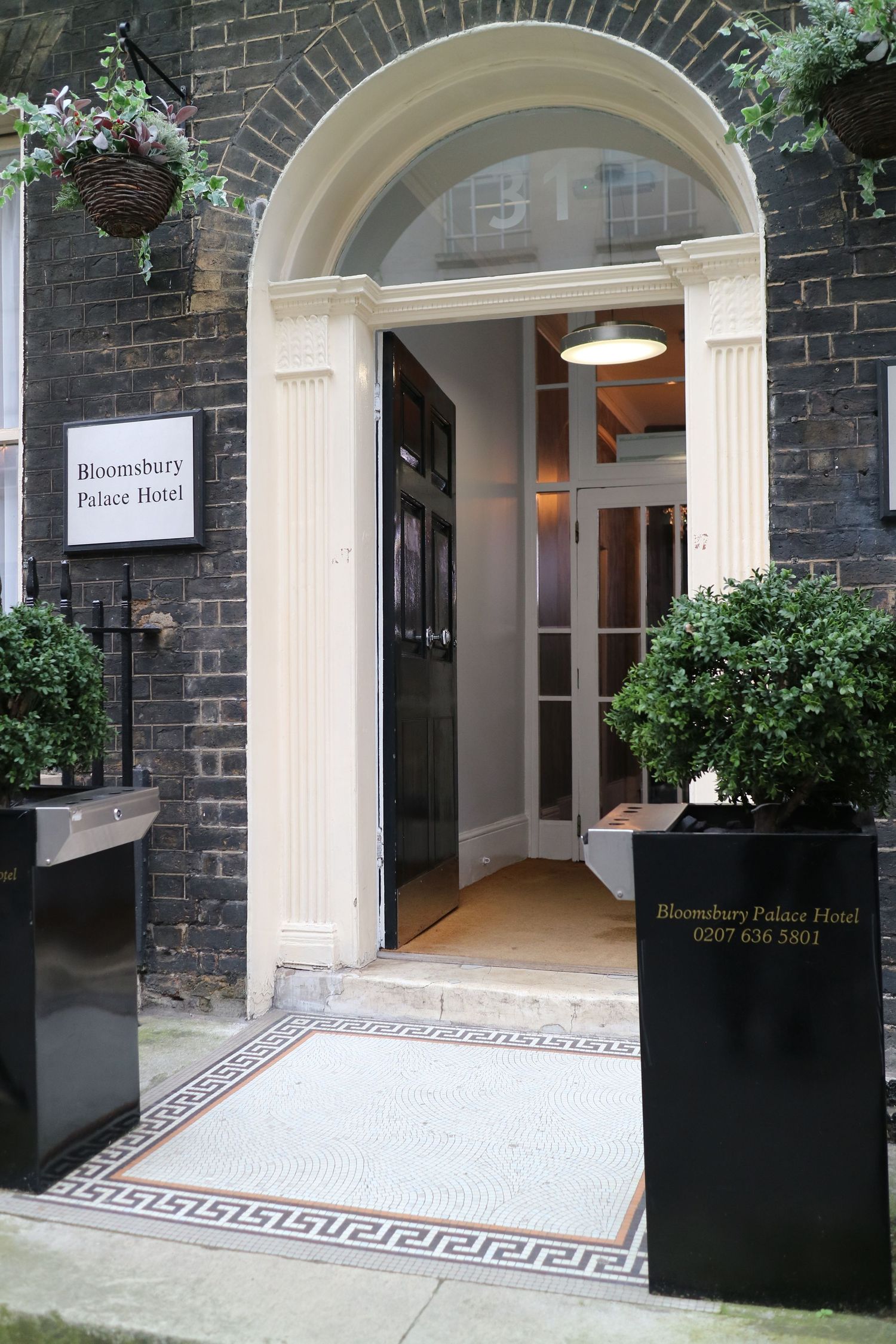 Architectural venue photography of a luxury London hospitality entrance facade, captured by ARIETA Studios.