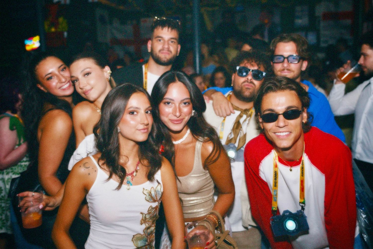 Group of friends smiling together at London party event by ARIETA Studios.