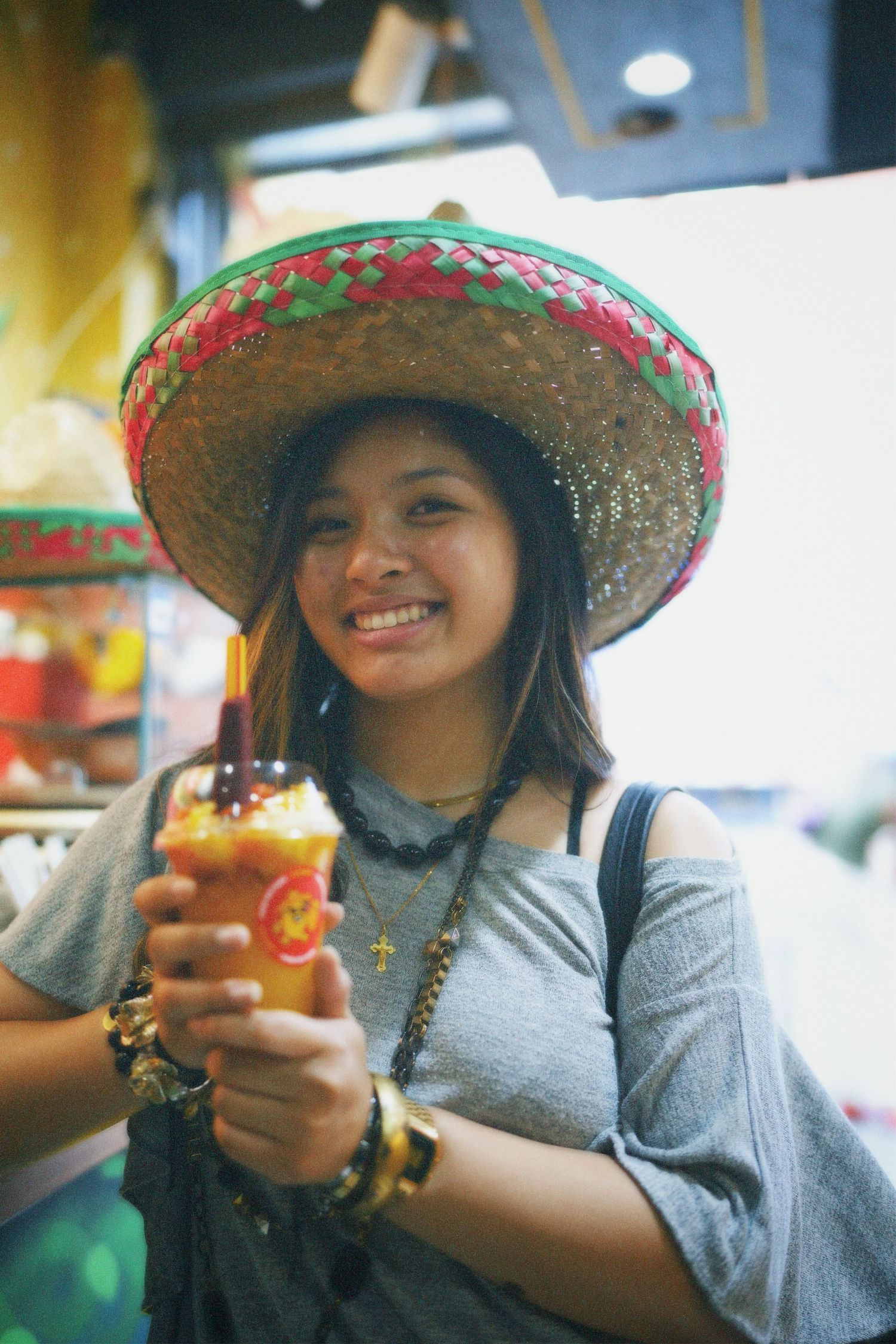 Alvernia wearing sombrero holding tropical drink, commercial photography by ARIETA Studios.