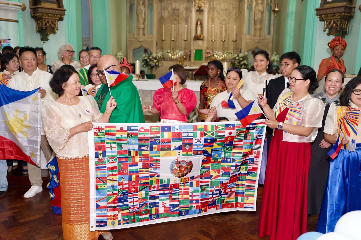 Congregation holding world flags banner at church altar during Culture Day by ARIETA Studios.