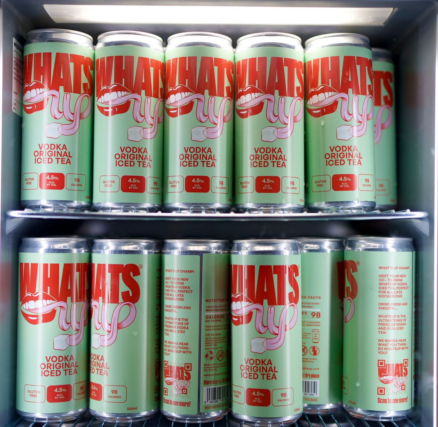 Rows of green and red WhatsUp Vodka Original Iced Tea cans chilled inside an event venue fridge. Photo by ARIETA Studios.
