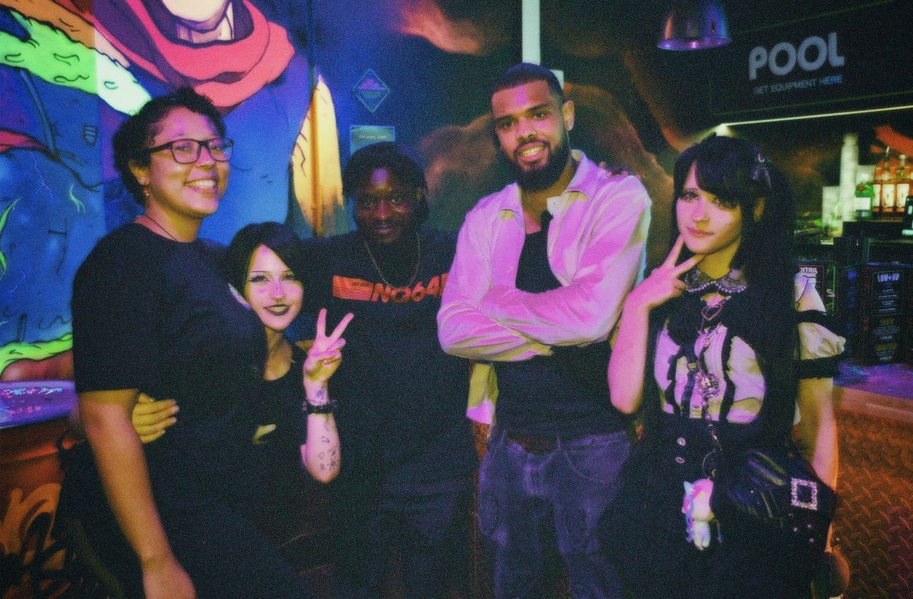 NQ64 Soho staff crew posing in branded t-shirts during opening night at Orange Yard, London.