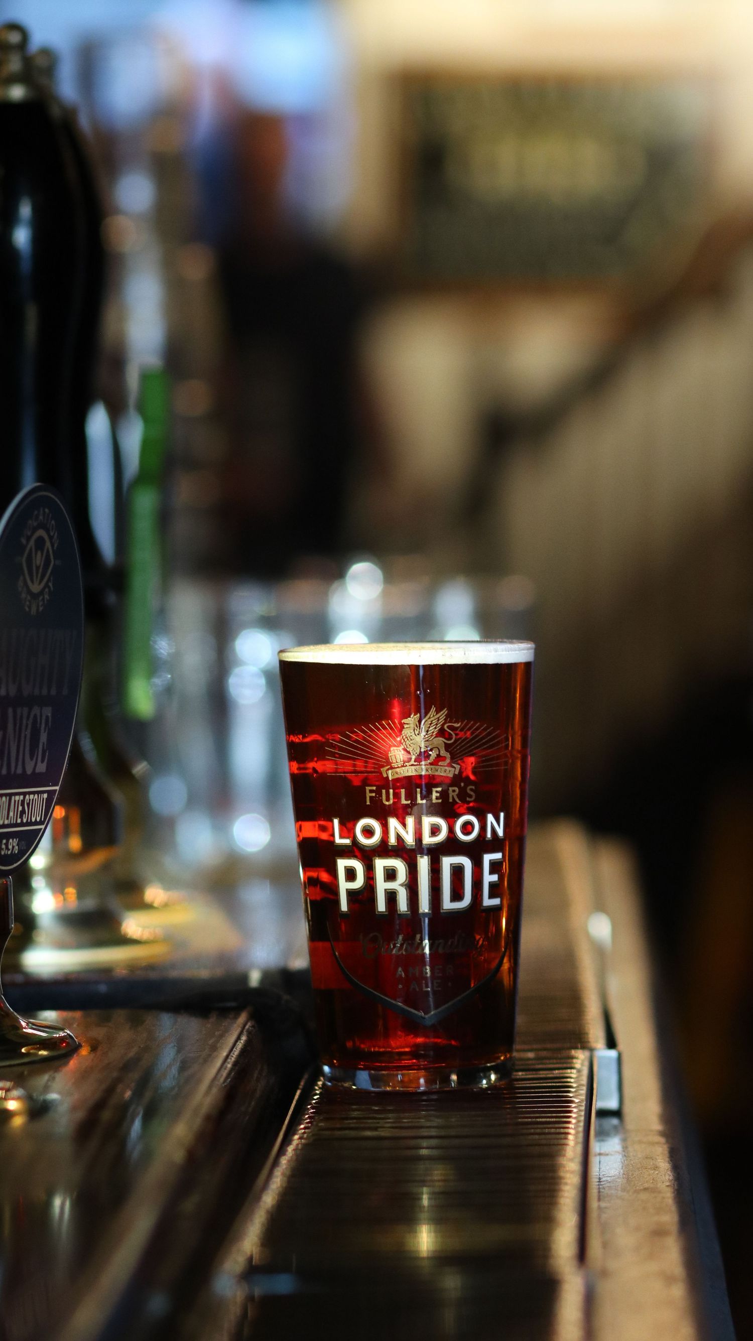 Crisp macro commercial shot of a London Pride pint glass on a bar counter, captured by London-based ARIETA Studios.
