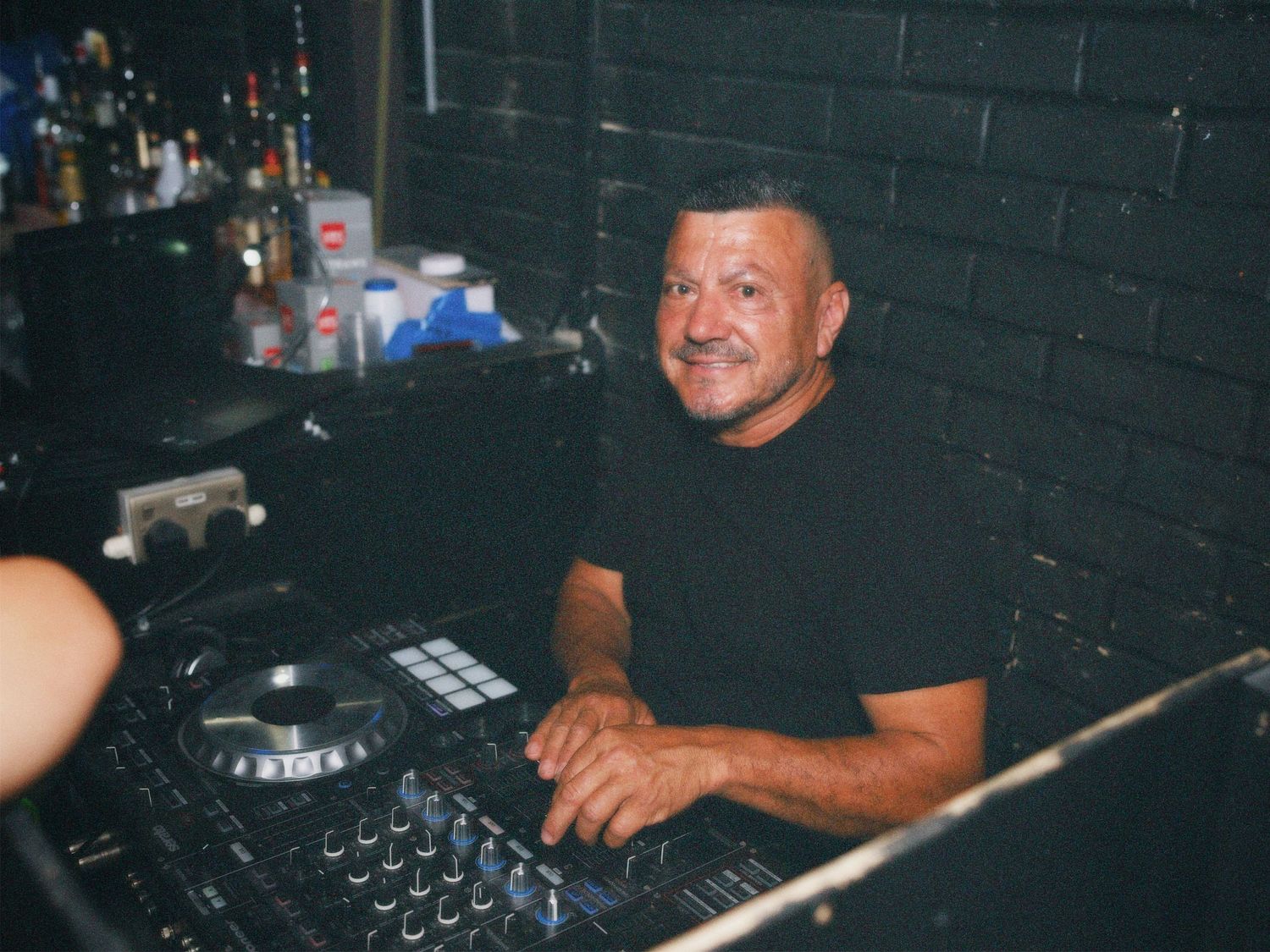DJ mixing tracks on decks at Paradise Super Club in Vauxhall captured by ARIETA Studios.