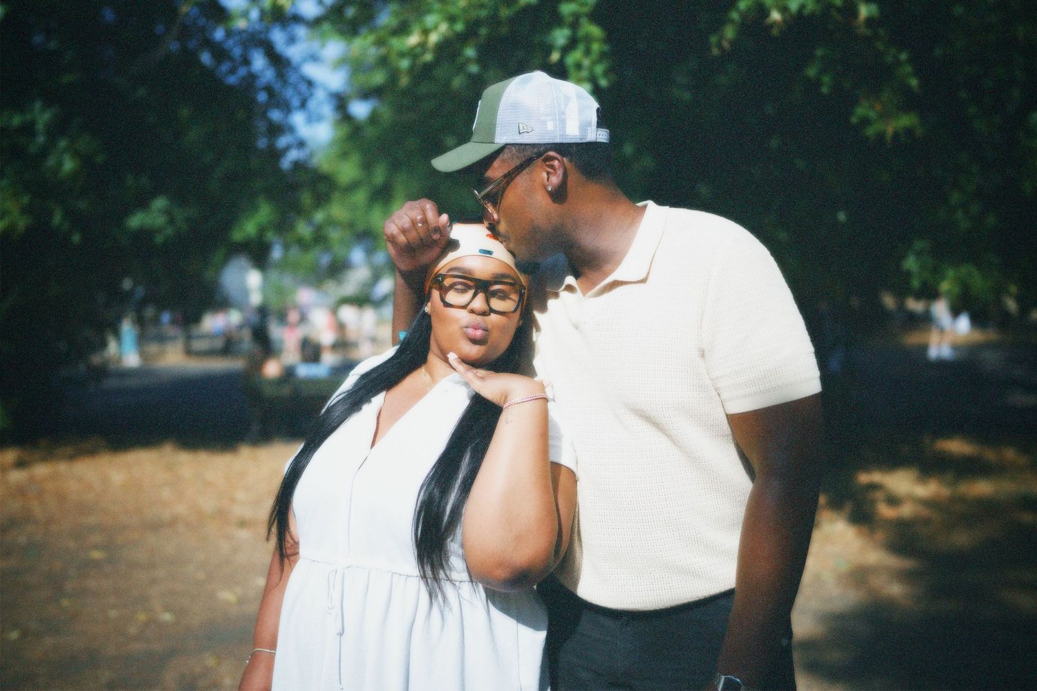 brother and sister, Kevin and Chantelle posing together in soft natural sunlight during an outdoor celebration.