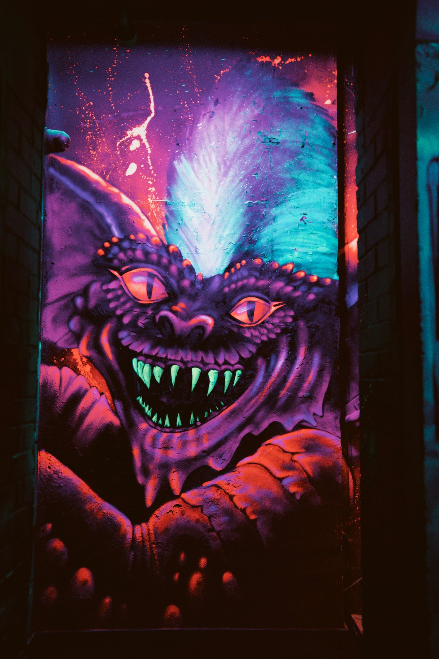 Close-up of vibrant UV arcade cabinet artwork inside NQ64 Soho in Orange Yard.