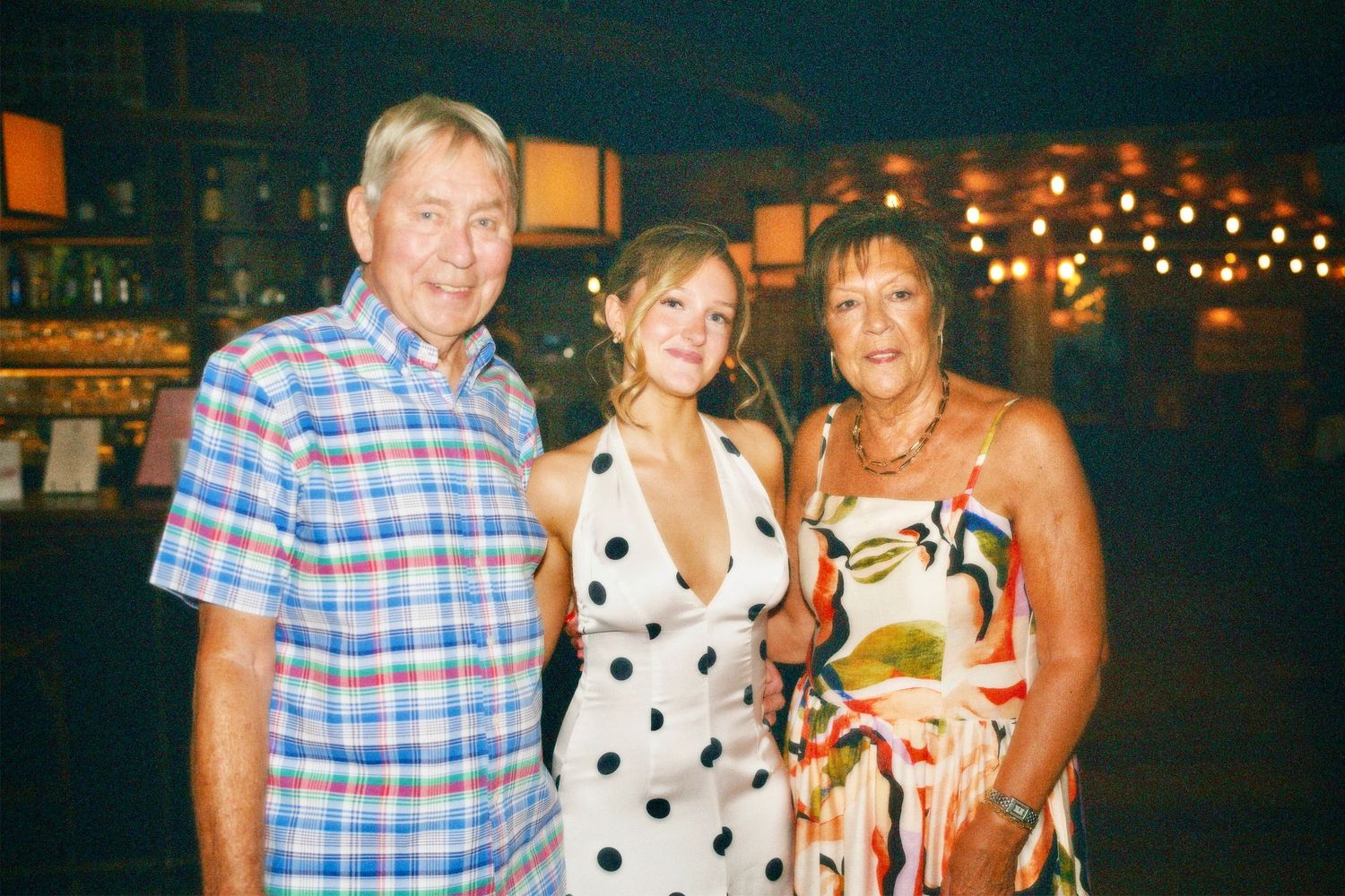 Woman posing with guests at a milestone 21st birthday party event covered by ARIETA Studios.