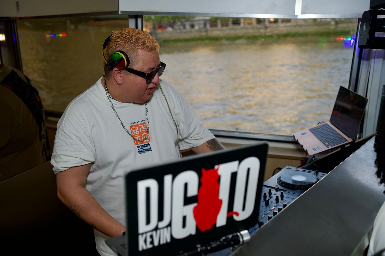 DJ mixing set on boat decks with River Thames views in London by ARIETA Studios.