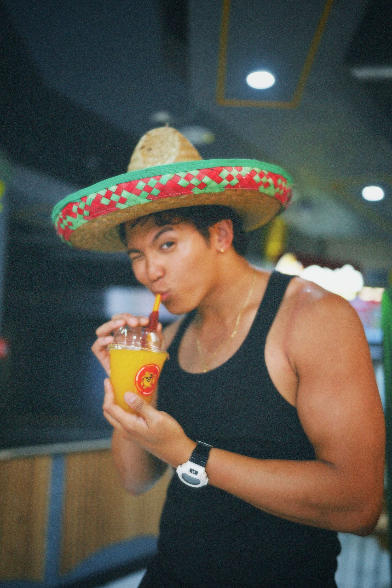 Alastair Arieta wearing a sombrero drinking a Chamigos fruit slushie in London commercial shoot by ARIETA Studios.