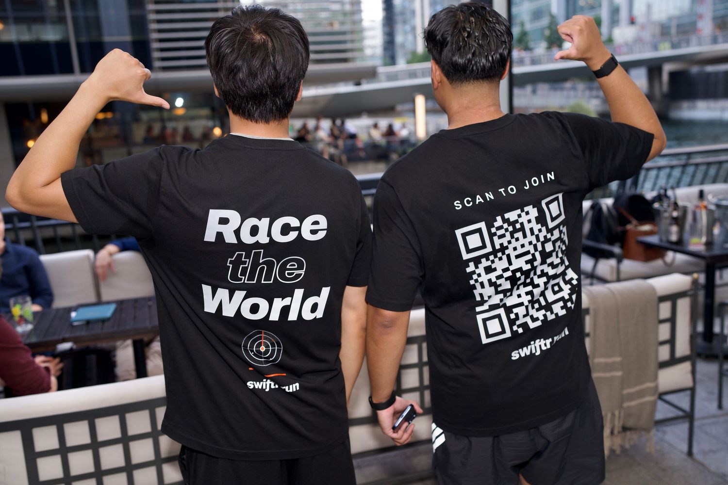 Two men showing back of swiftr t-shirts with Race the World text and QR code by ARIETA Studios.