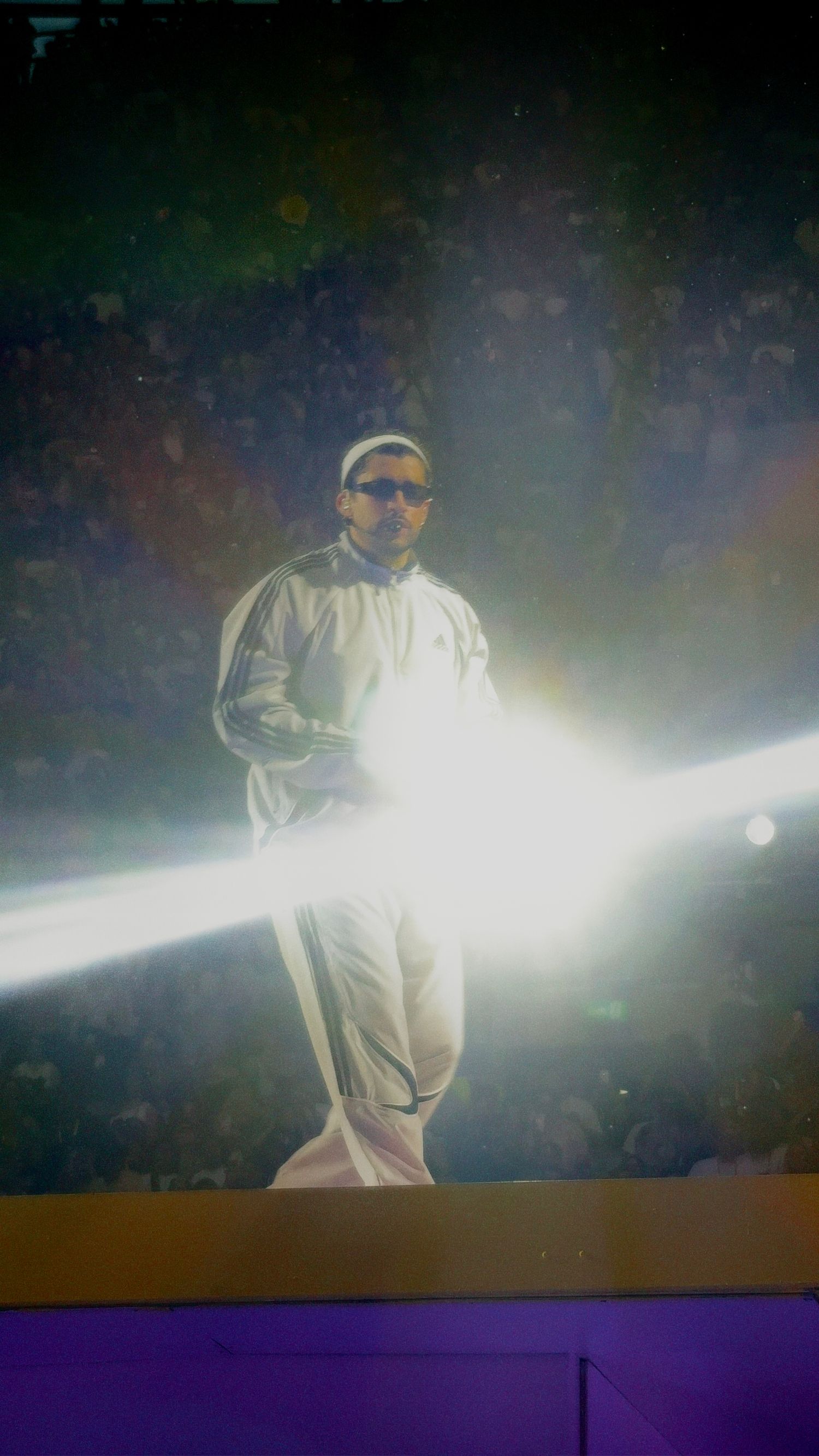 Performer highlighted in stage spotlight during live show captured by ARIETA Studios.
