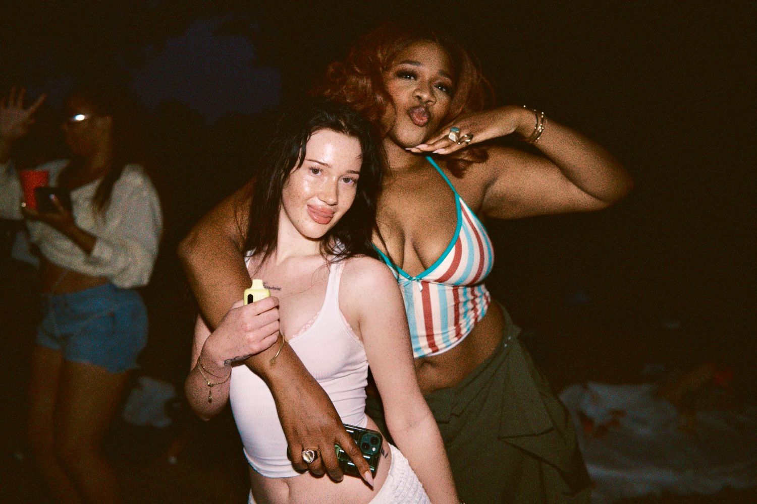 Two women posing together at outdoor summer event event coverage by ARIETA Studios.