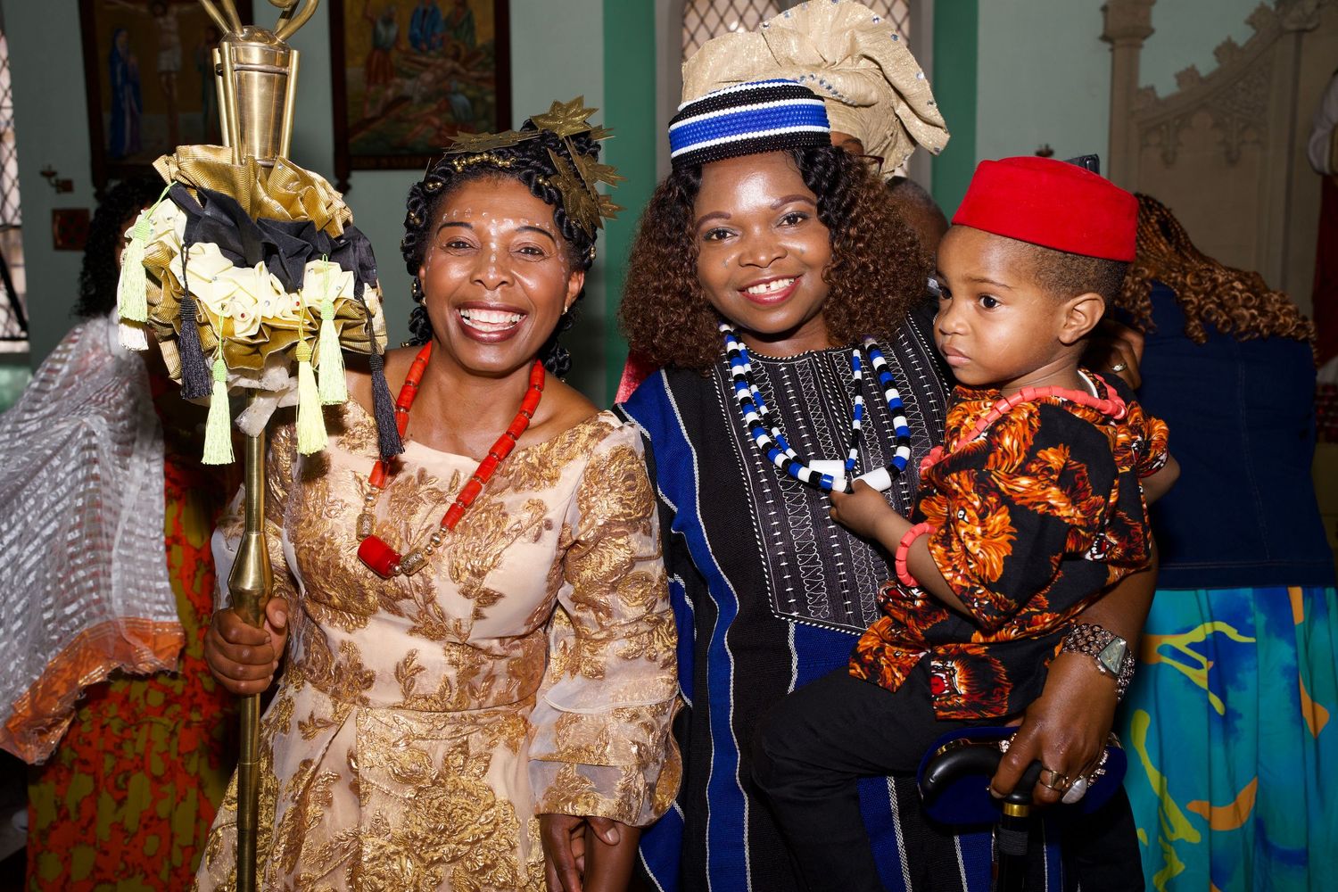 Women and child in traditional attire posing during culture celebration captured by ARIETA Studios.