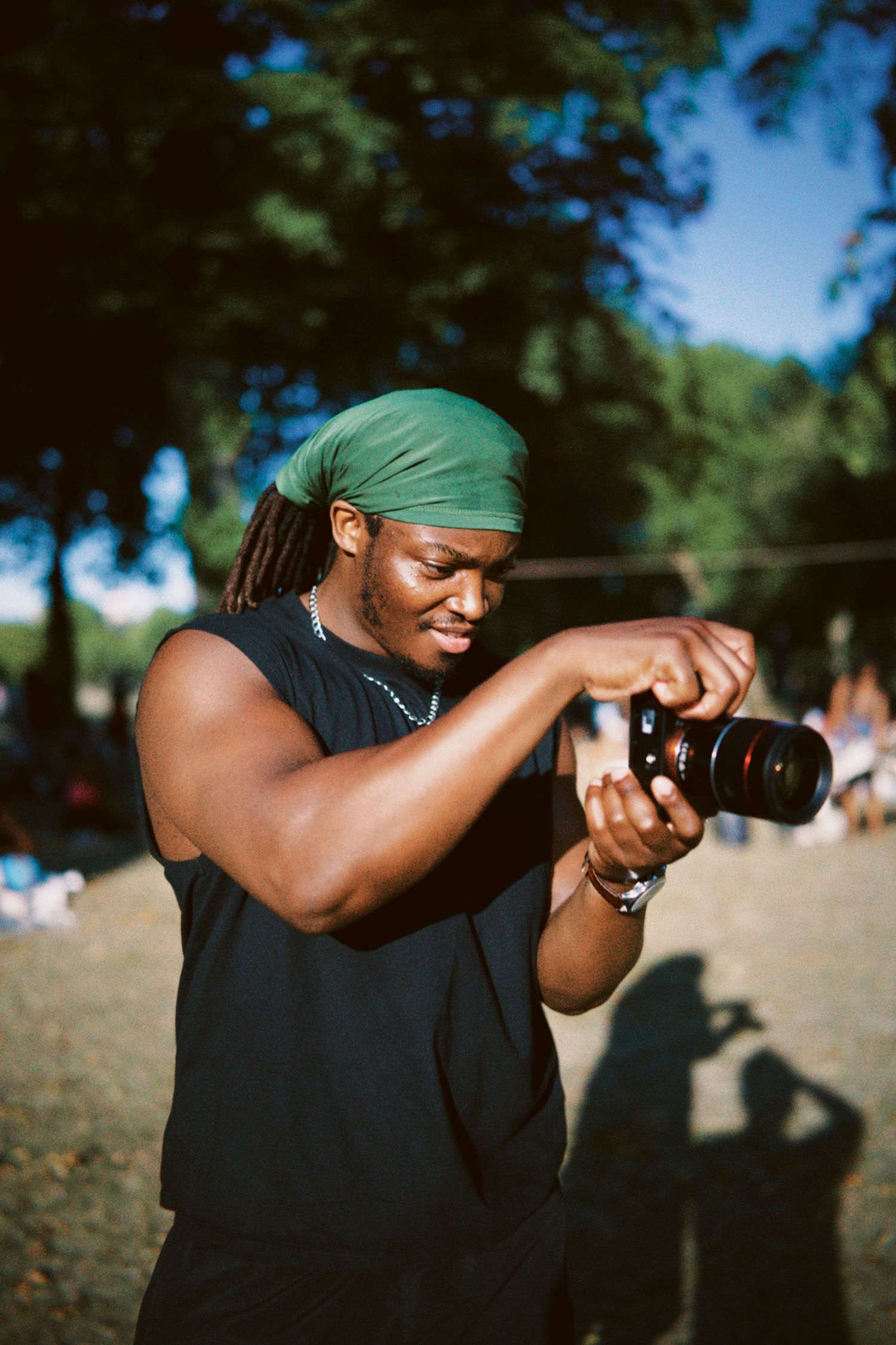 Photographer capturing shots in green bandana at London outdoor event by ARIETA Studios.