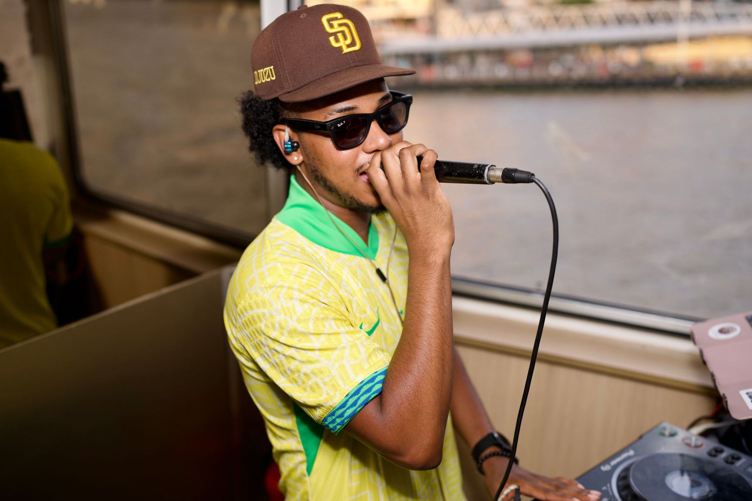 MC performing into microphone at On the Thames boat party by ARIETA Studios