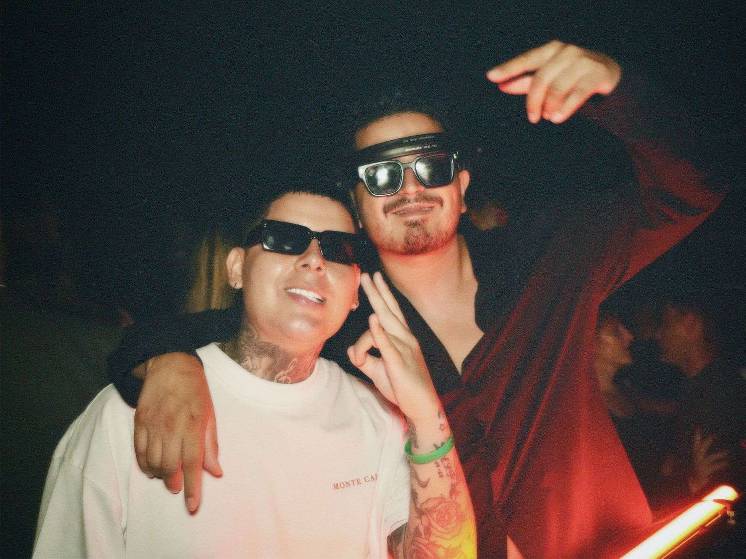 Two men wearing sunglasses posing together at Paradise Super Club in Vauxhall by ARIETA Studios.