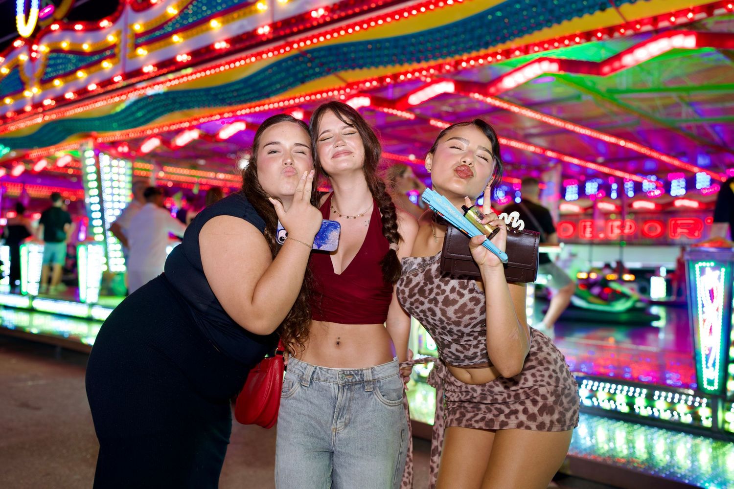 Friends posing by fairground rides / Amigas posando frente a las atracciones del Real.