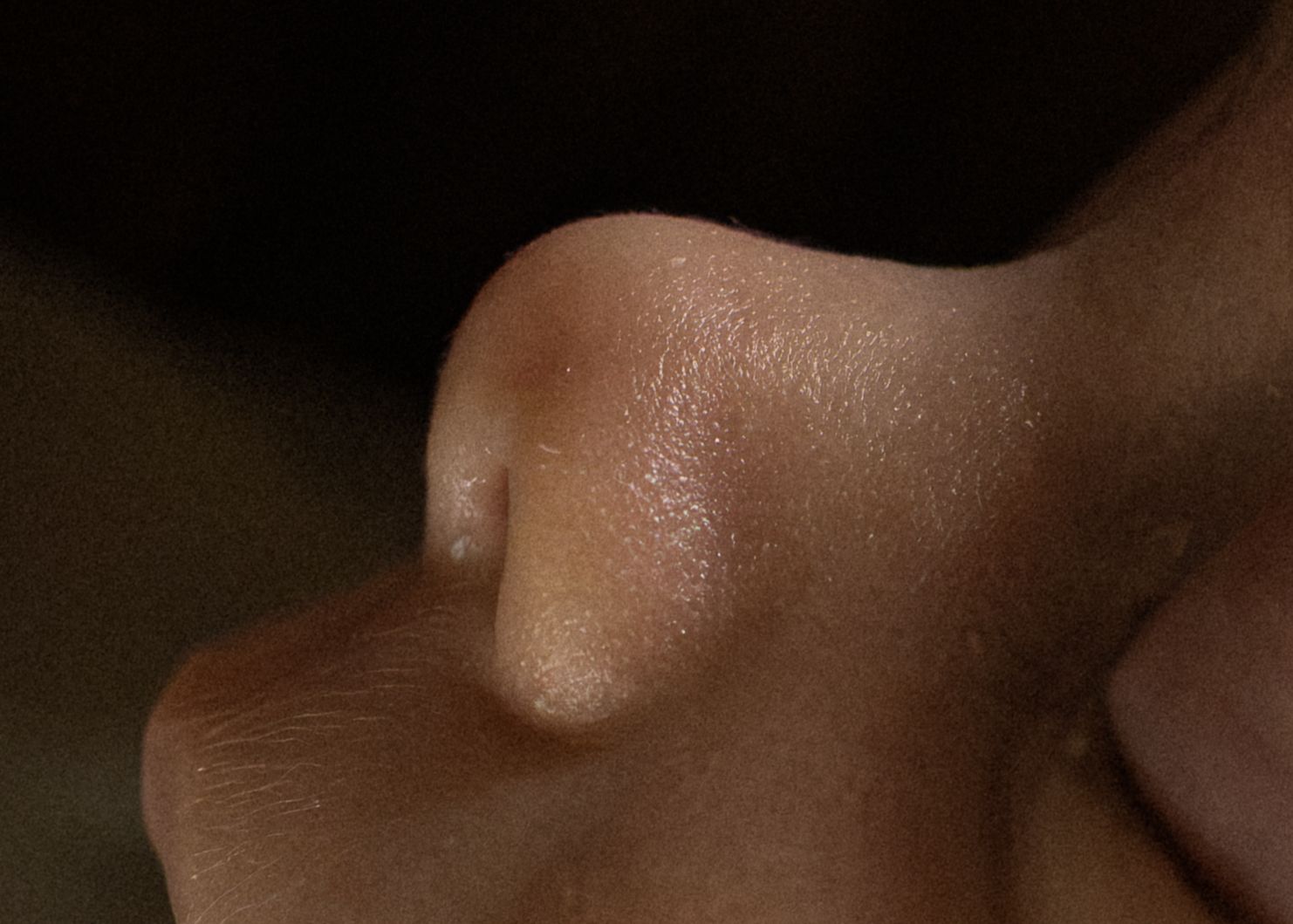 Close-up of a newborn baby's tiny nose showing delicate skin details.