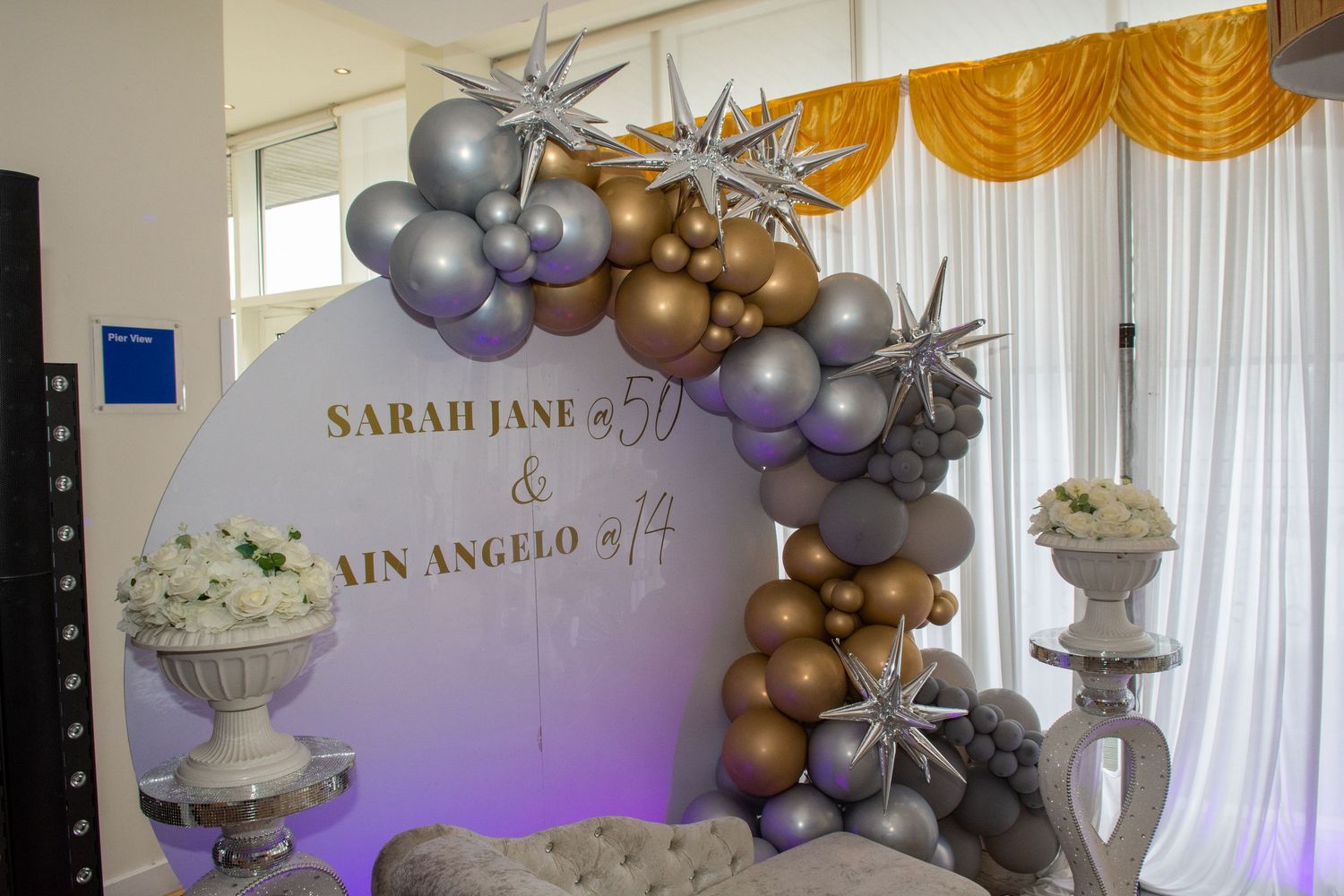 Elegant birthday party backdrop with gold and silver balloons for Sarah Jane and Ain Angelo.