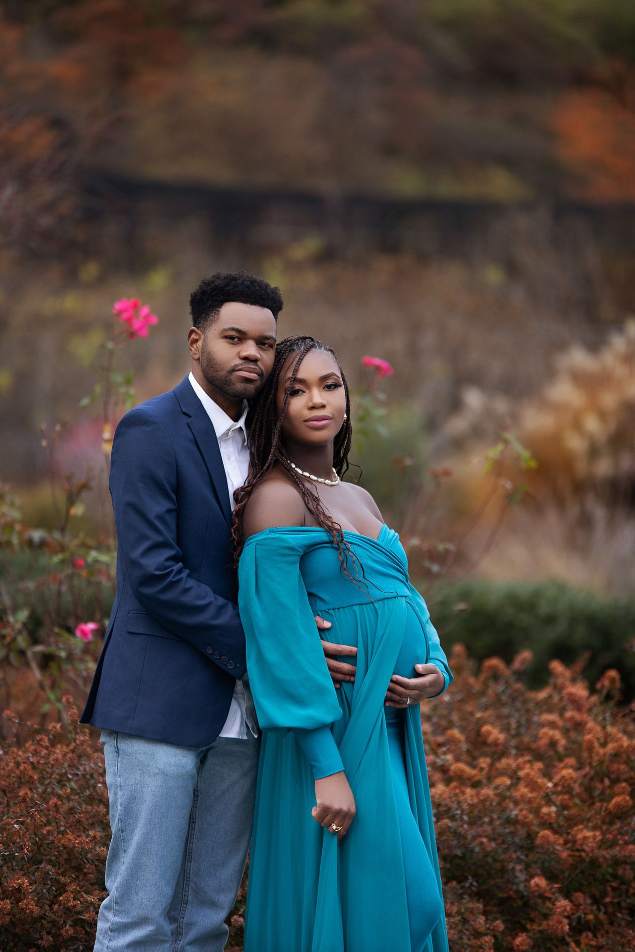 pregnant woman posing for maternity photography in beach boardwalk with husband and children