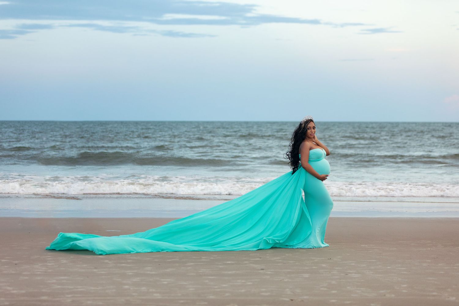 pregnant woman posing for maternity photography in beach boardwalk with husband and children