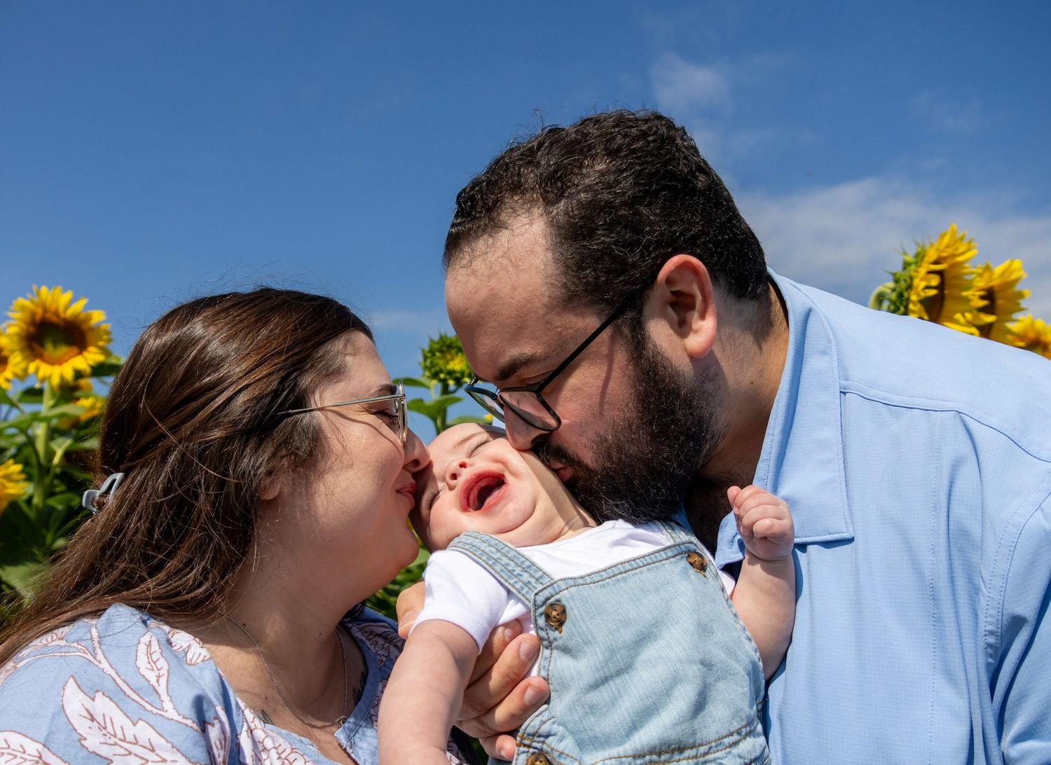 Candid moment of a family walking through the sunflower patch at Pingle's Farm Oshawa