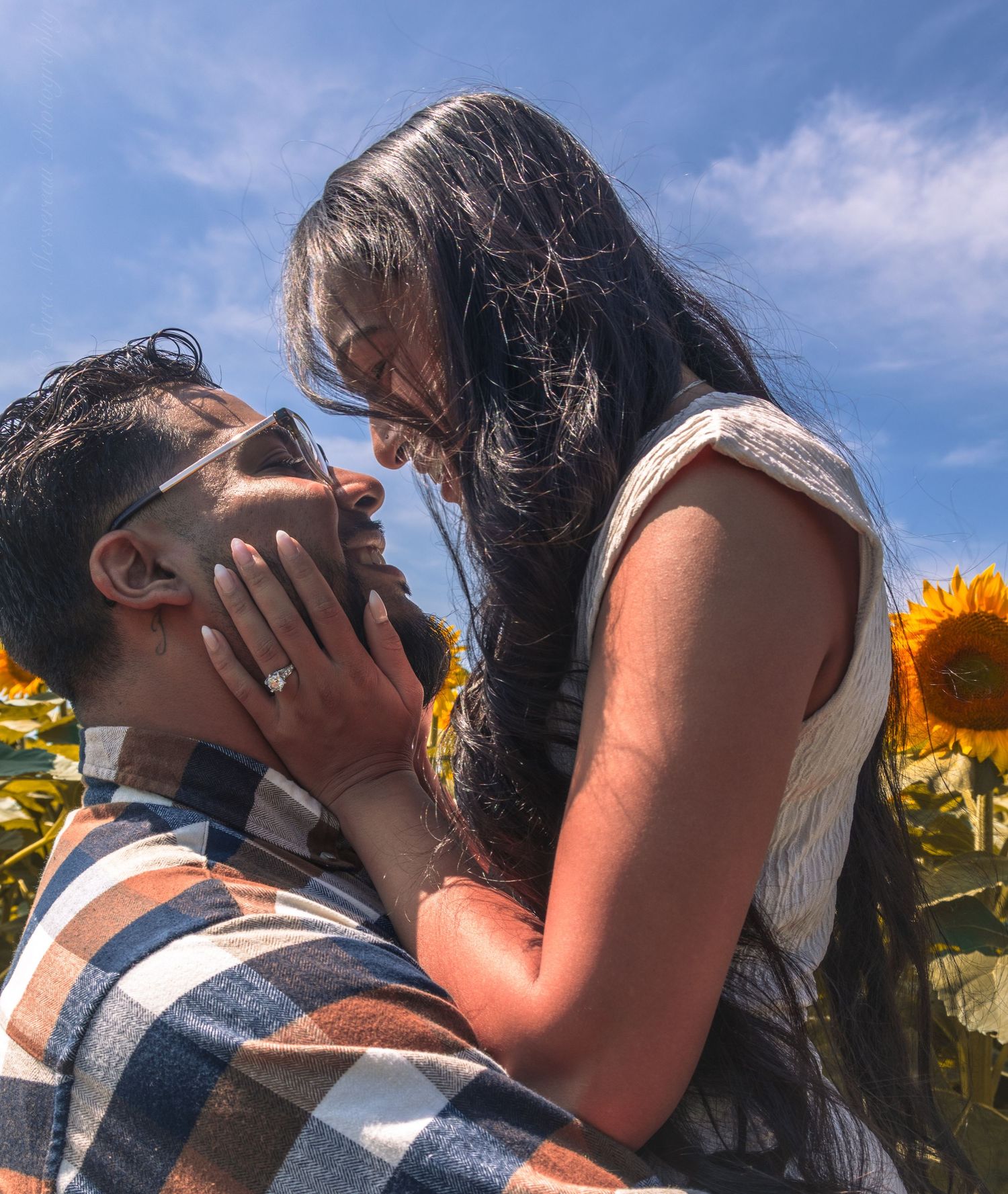 Close-up shot of a couple embracing with a visible engagement ring in Durham Region