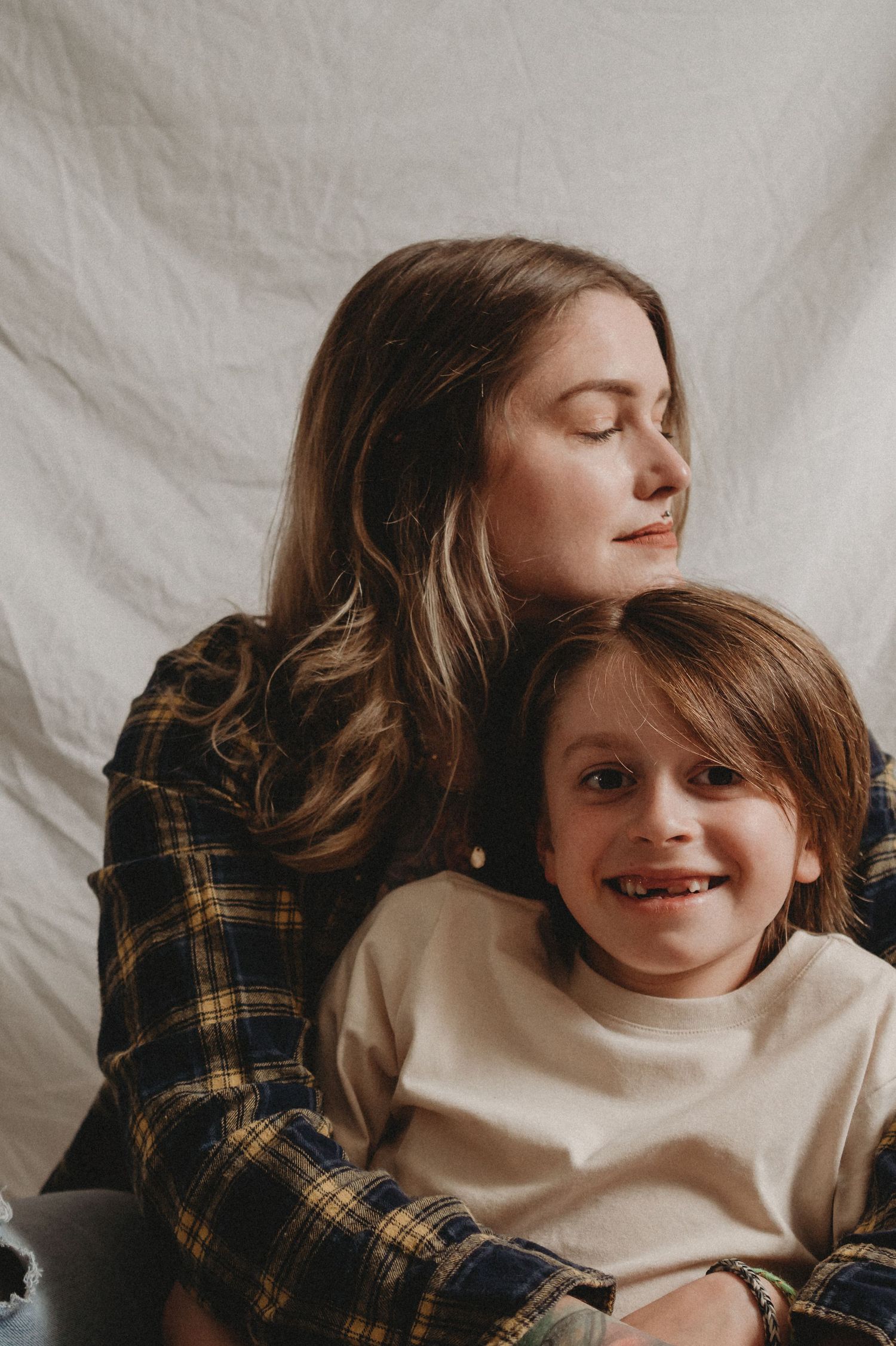 Intimate family portrait showing sweet moment between parent and child.