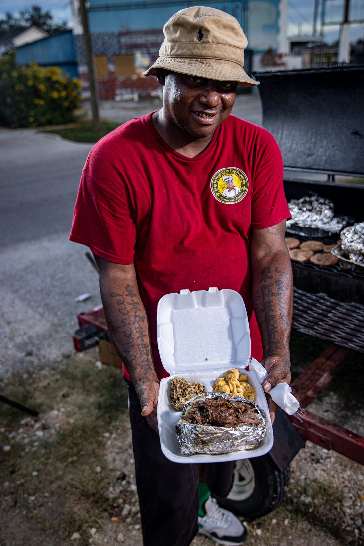 Owner of Mike's Catering serving a plated meal