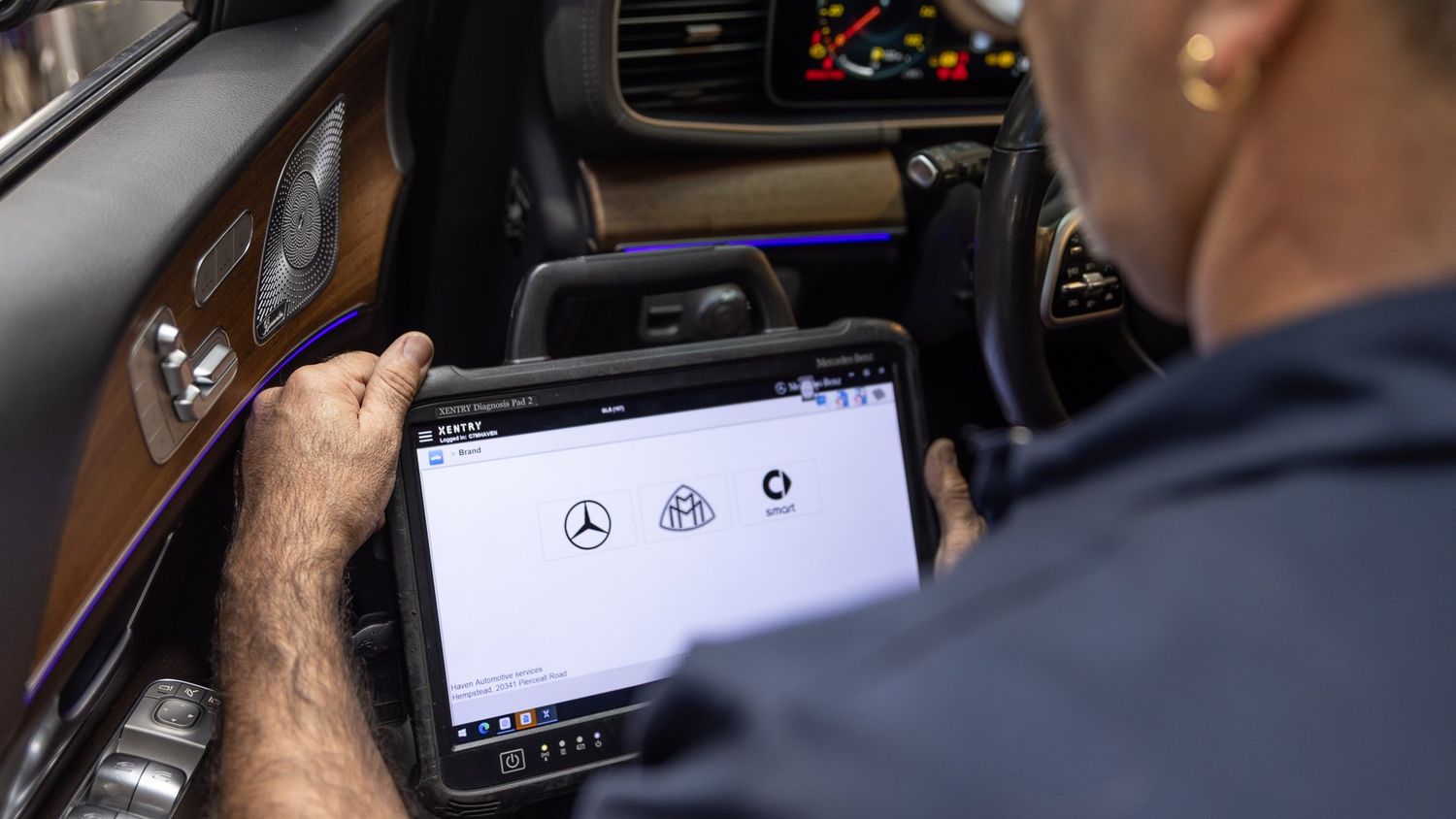 Technician running factory diagnostics on a Mercedes-Benz at ABR Houston West