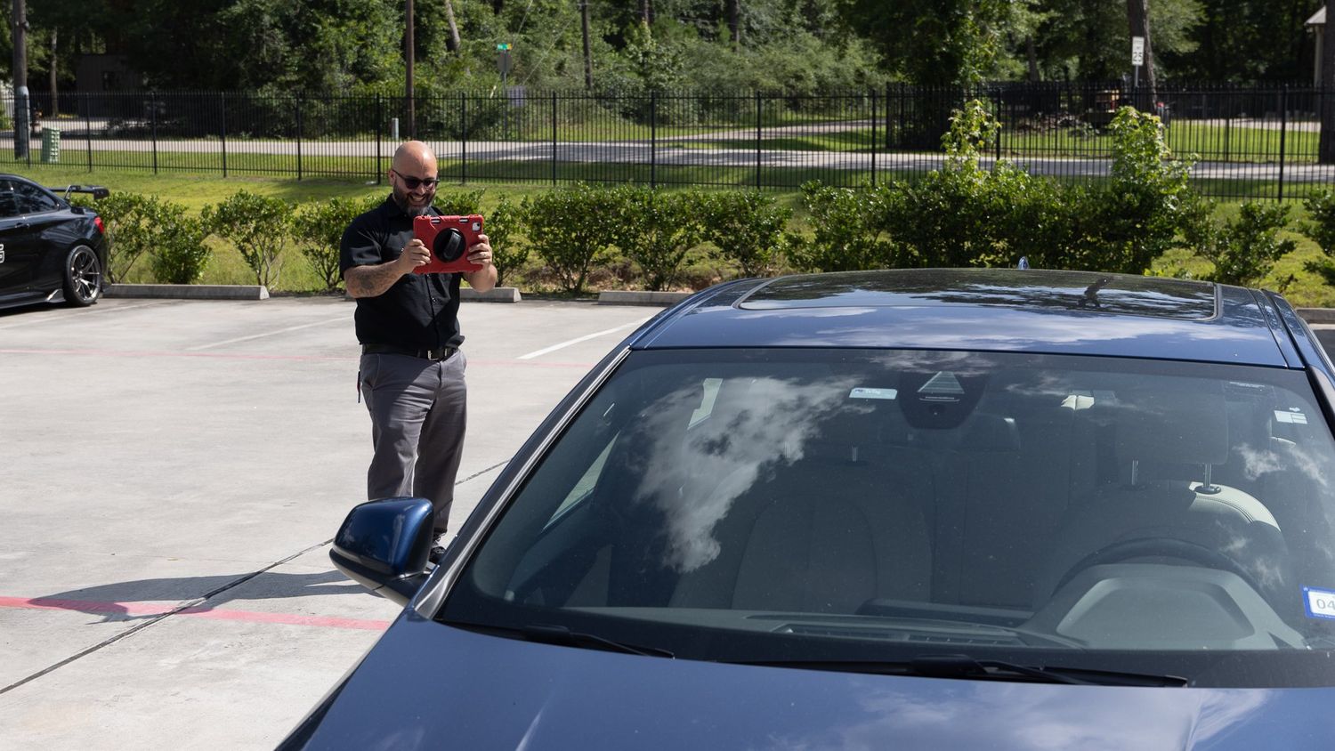 Service advisor walking around a customer's vehicle at drop-off, ABR Houston