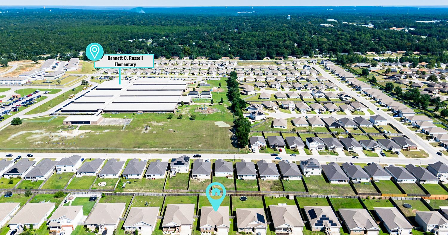 Aerial view of a suburban neighborhood near Ronald R. Bennett Elementary School in a wooded Florida community.