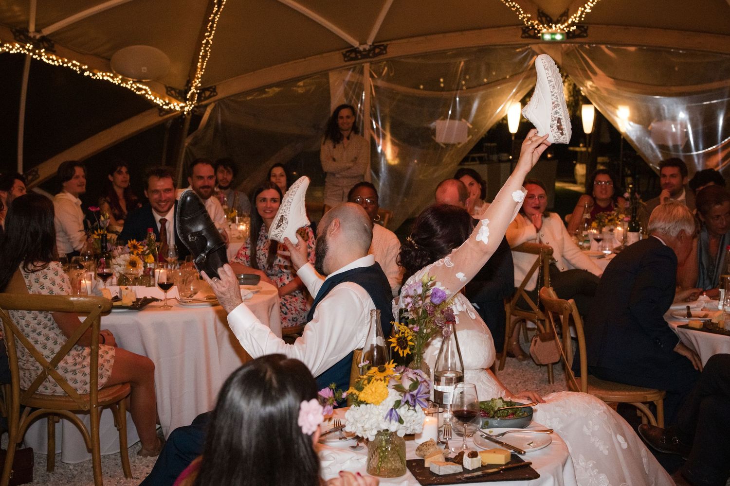 Guests celebrating around the dinner tables at a wedding reception at La Roche Couloir in the Chevreuse Valley.