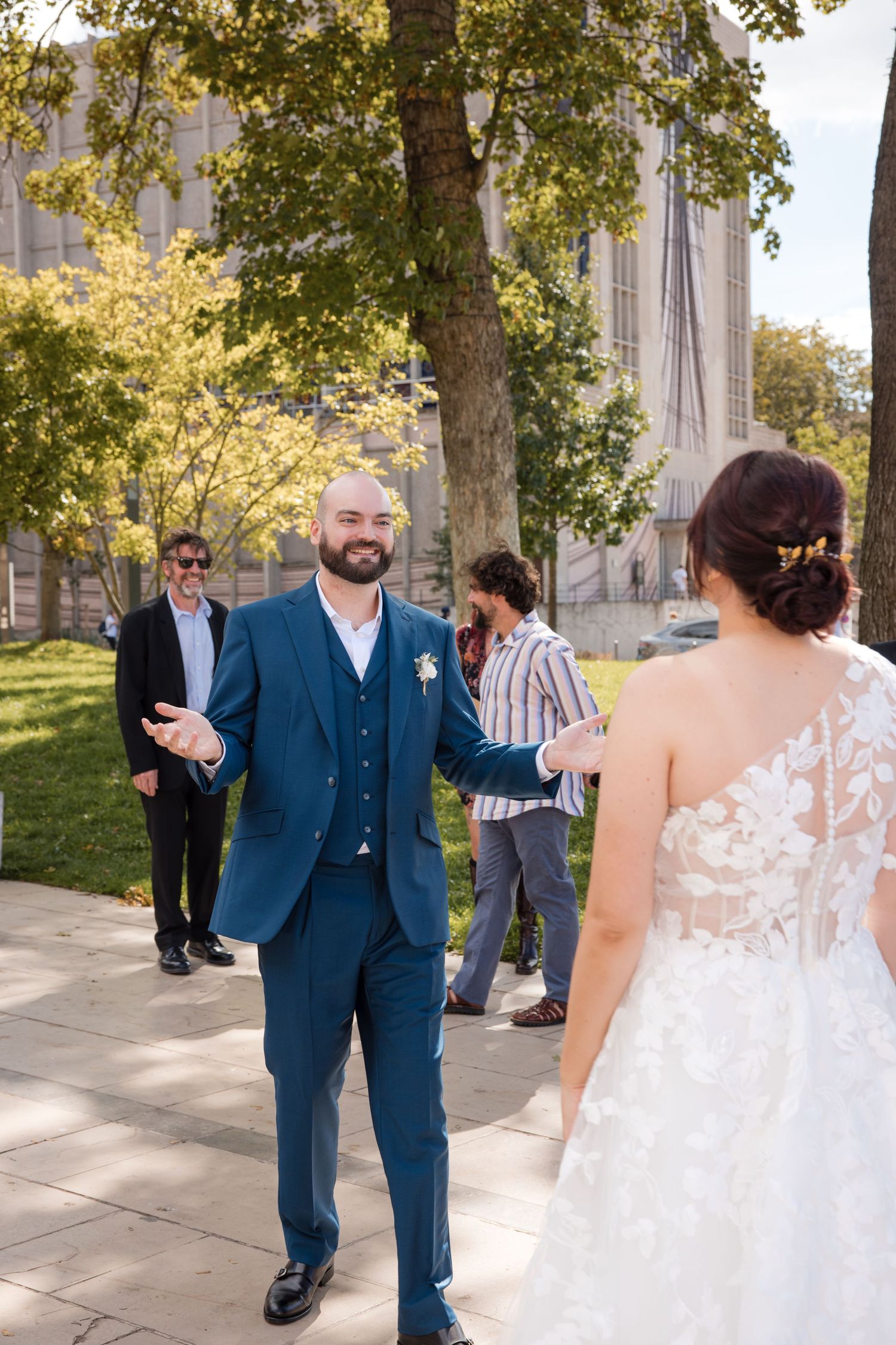 Groom reacting as he sees the bride in her wedding dress for the first time outside Montrouge town hall.