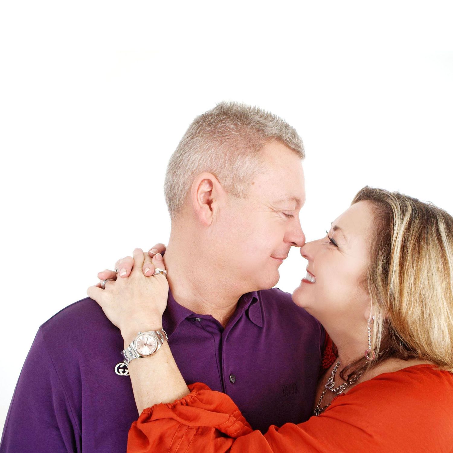 Couple in red and purple shirts sharing an intimate moment in a series of romantic poses against white background.