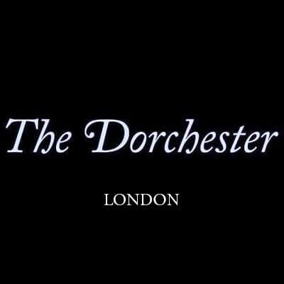 The Dorchester London luxury hotel logo in elegant white script on black background.