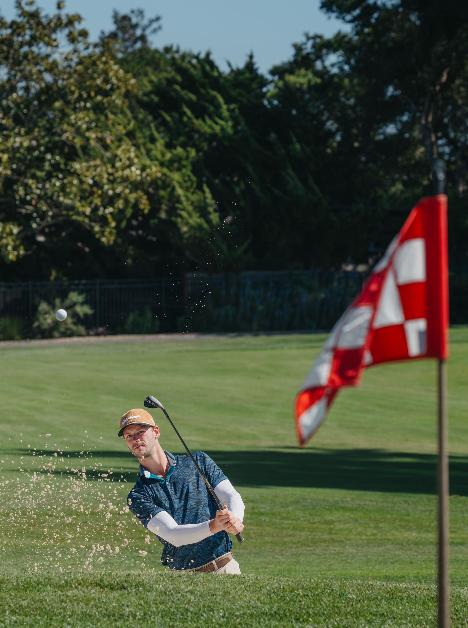 golf bunker shot with flag in the front