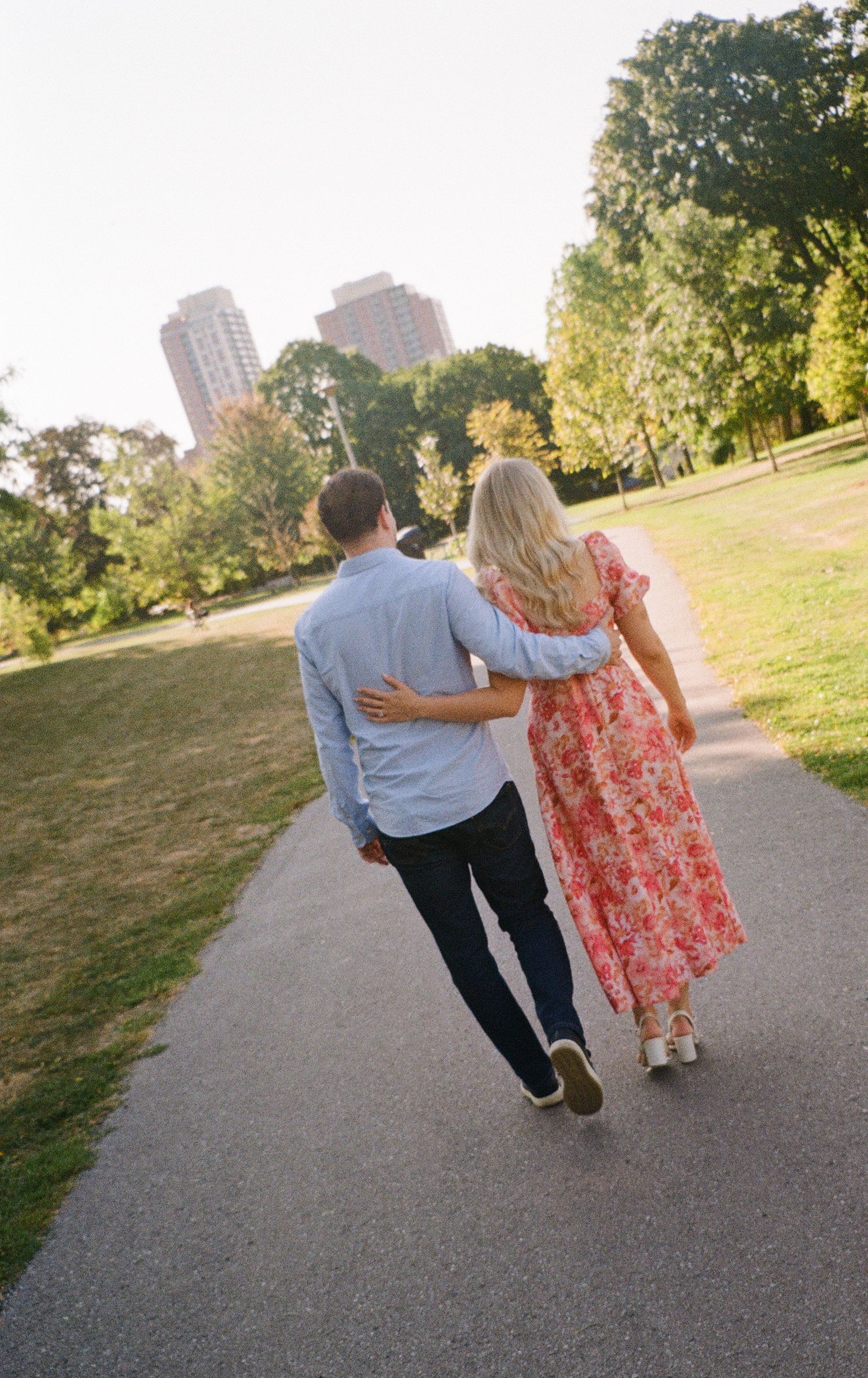 Couple walking through a sunlit garden during their Toronto wedding, captured in a candid documentary photography style