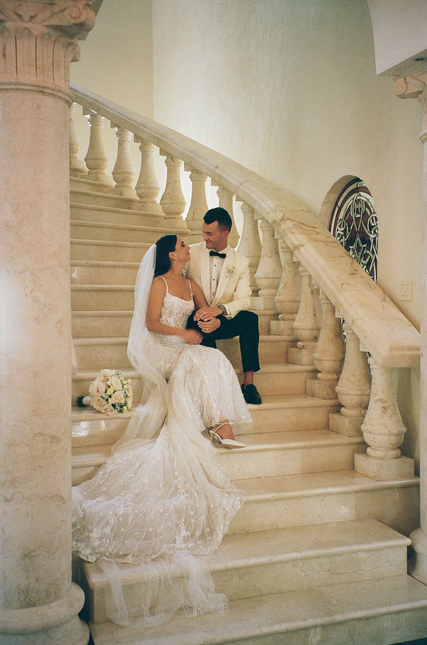 Bride and Groom sitting on stairs