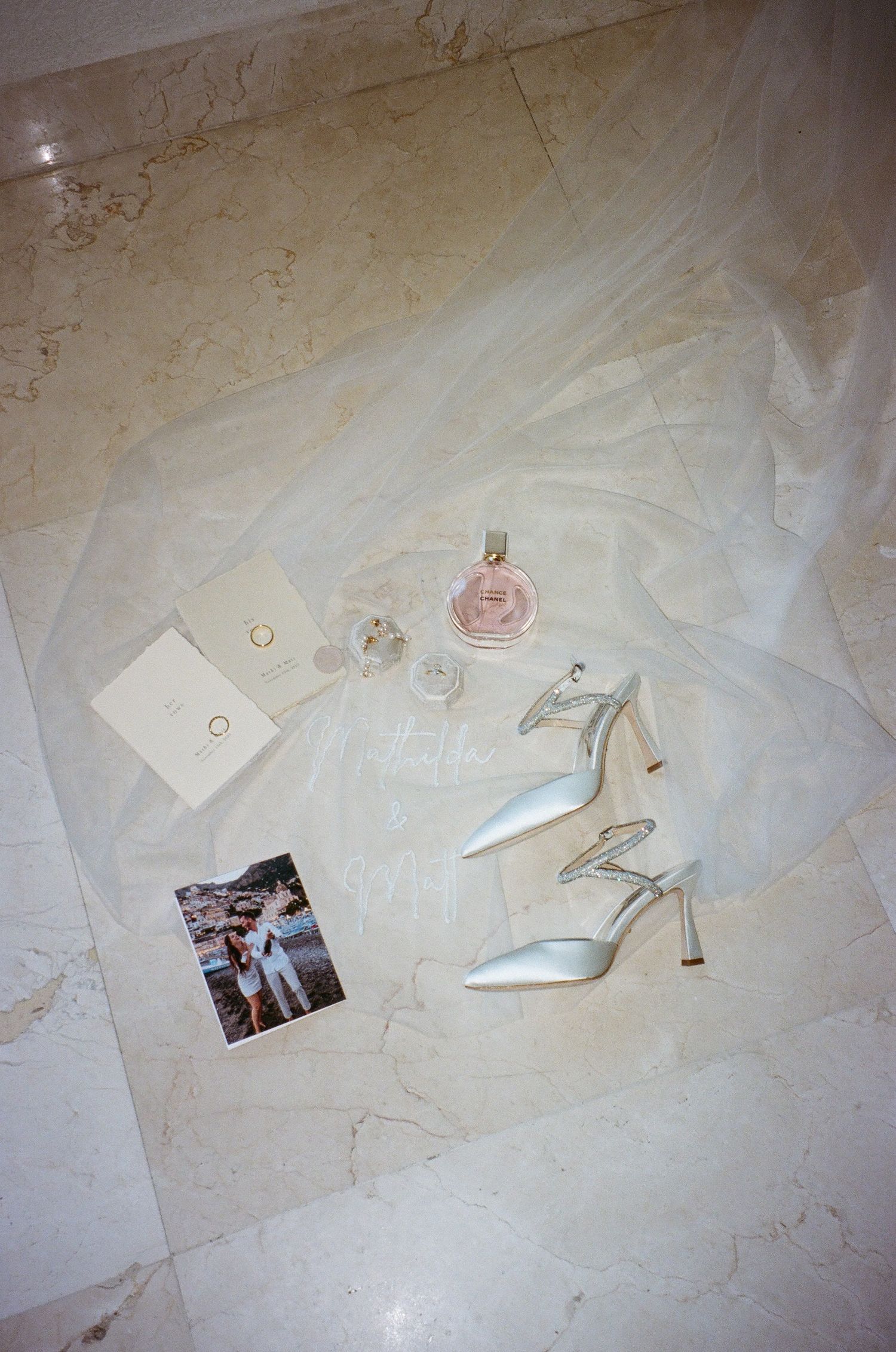 Romantic wedding details photographed in natural light, including rings, stationery and bridal accessories