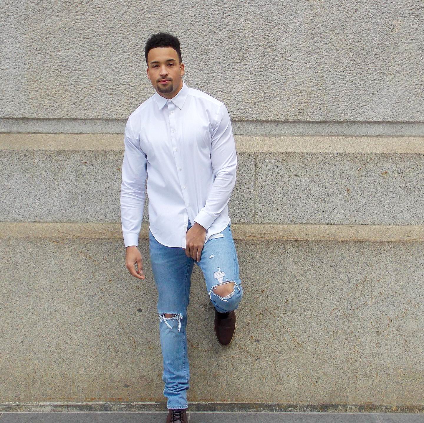 “Casual confidence against concrete texture—capturing style, posture, and the quiet strength of a moment shaped by light and simplicity.”