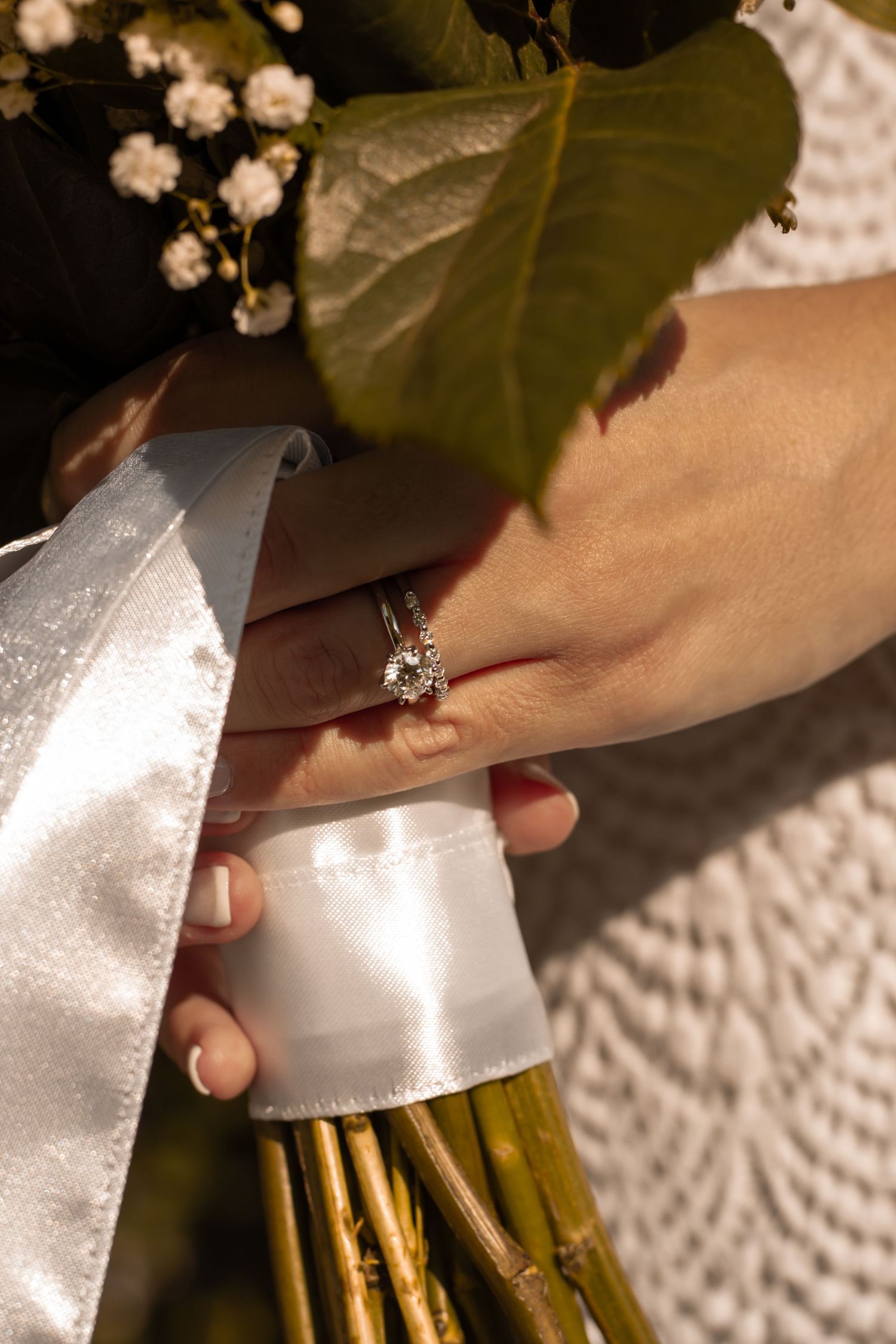 picture of bride's hand and ring wilst holding her bouquet