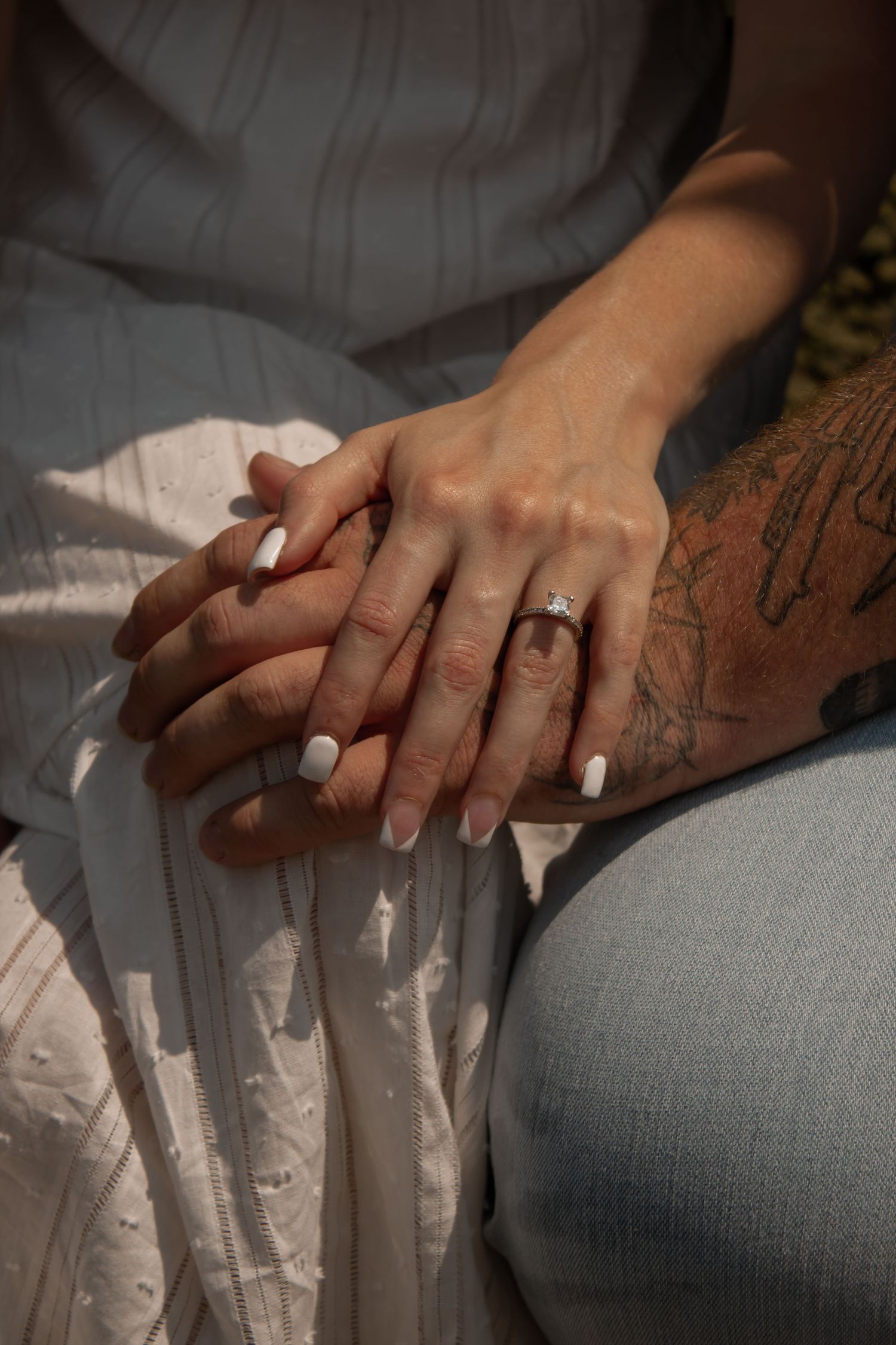 picture of couple's hands, showcasing the girls ring