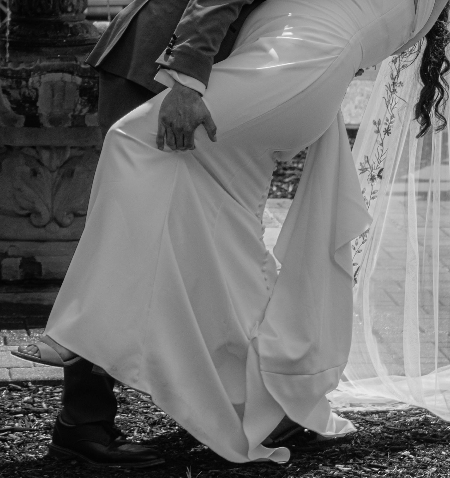 black and white close up picture of groom dipping bride