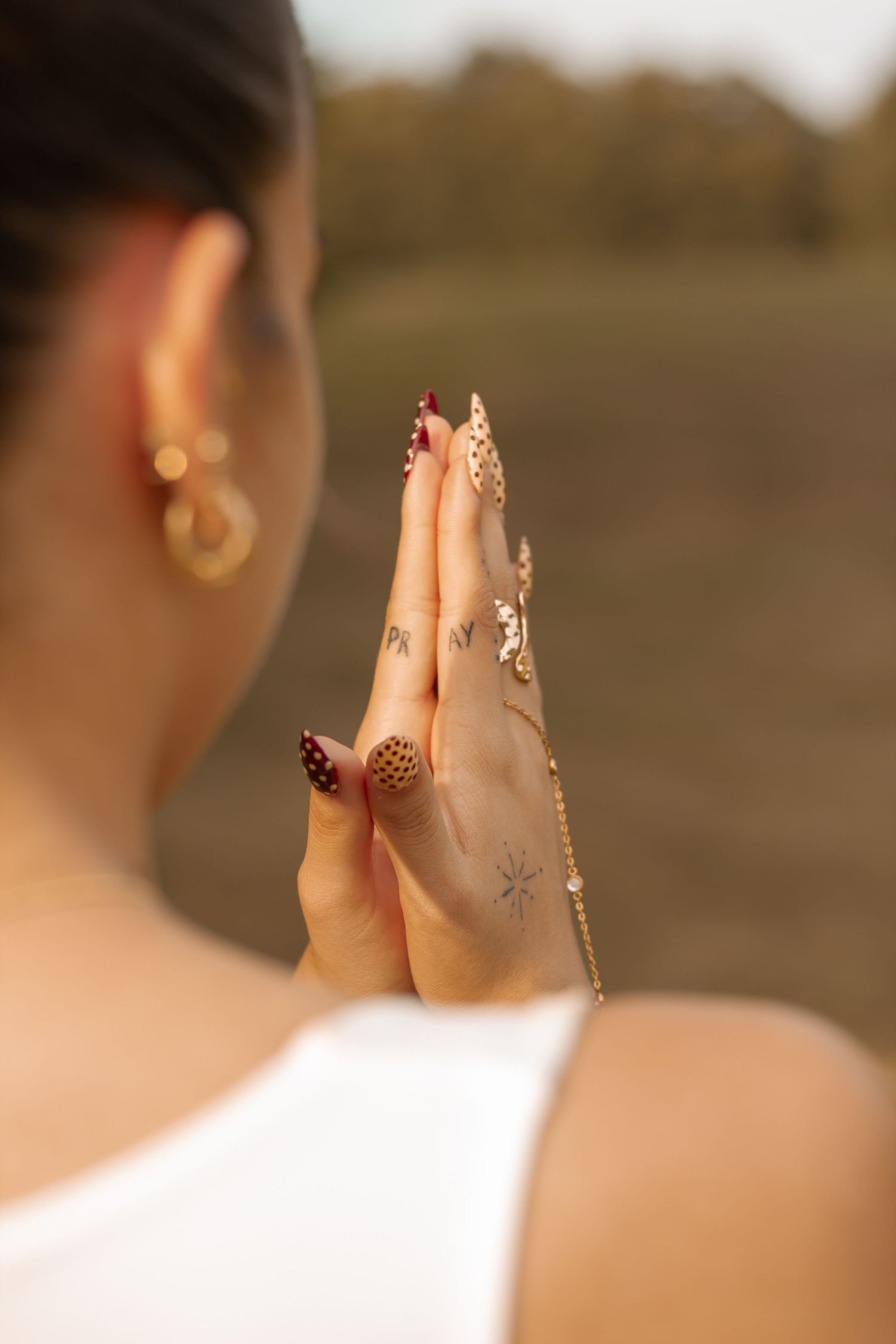 picture of girl from the back. She's holding her hands in prayer position.