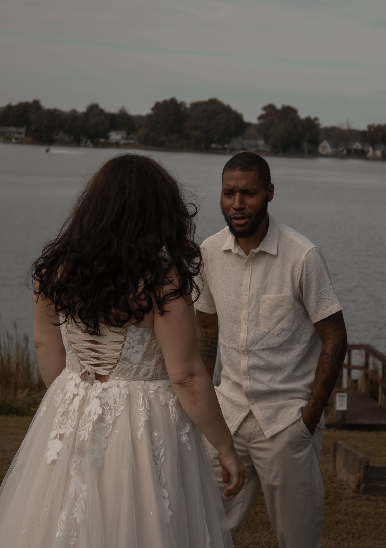 picture of bride and groom near beach looking at each other. bride