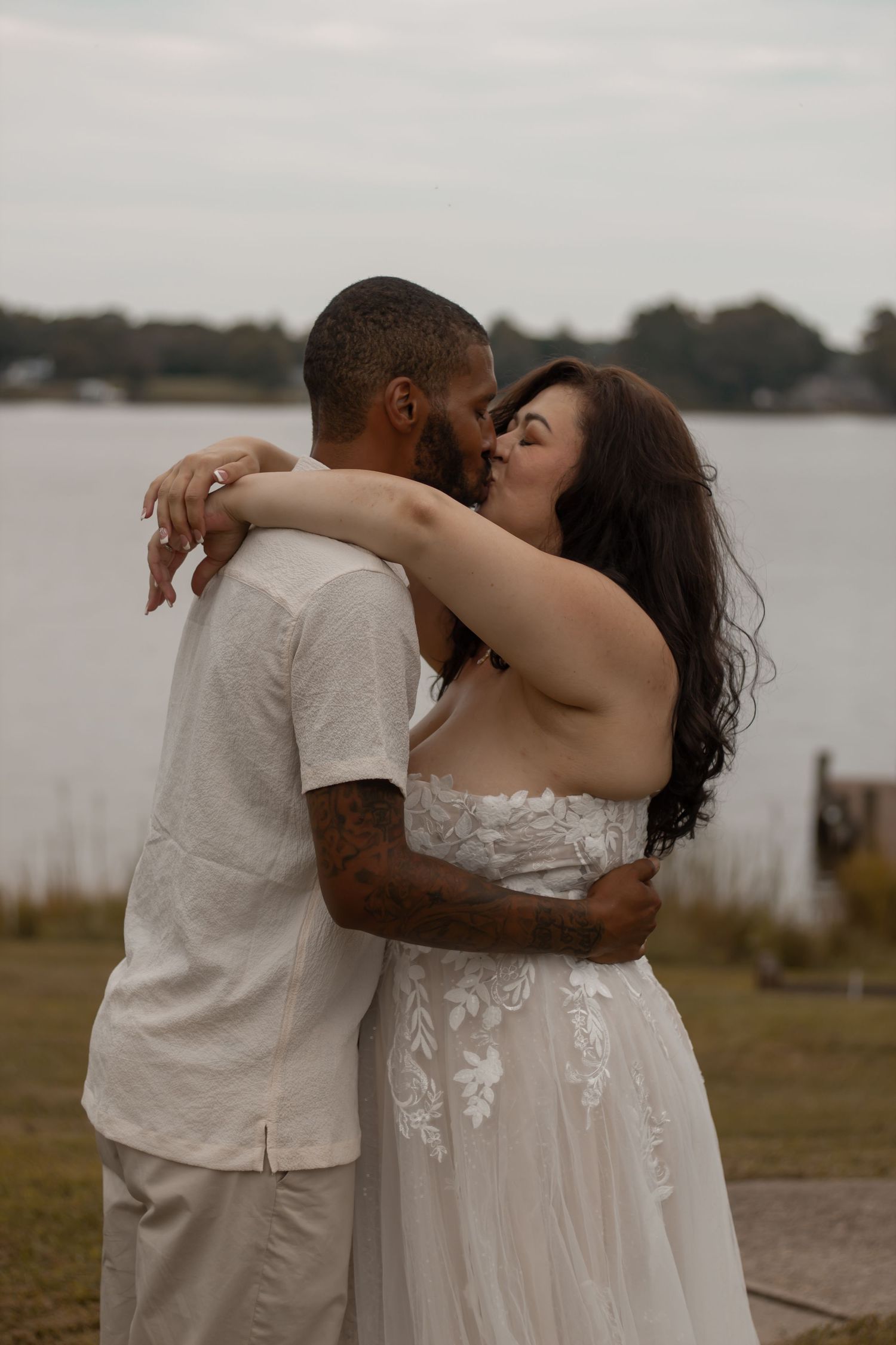picture of couple near beach holding each other and smiling