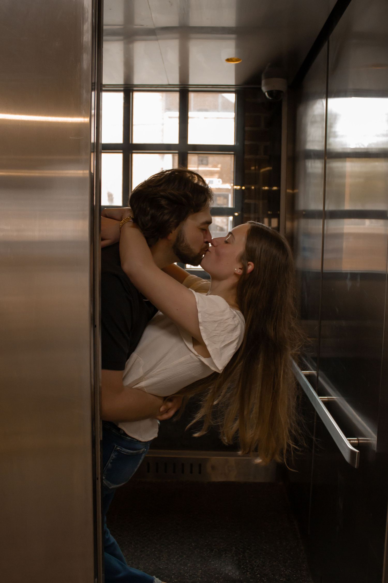 picture of couple, engagement, kissing indoors