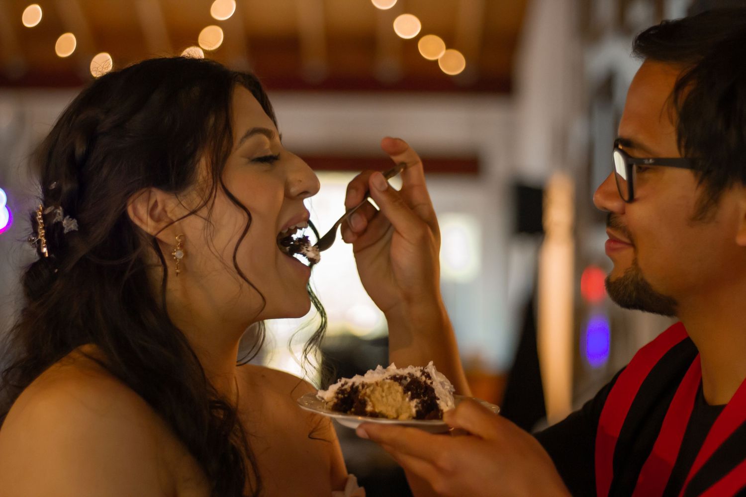 picture of groom feeding bride a bite of their cake